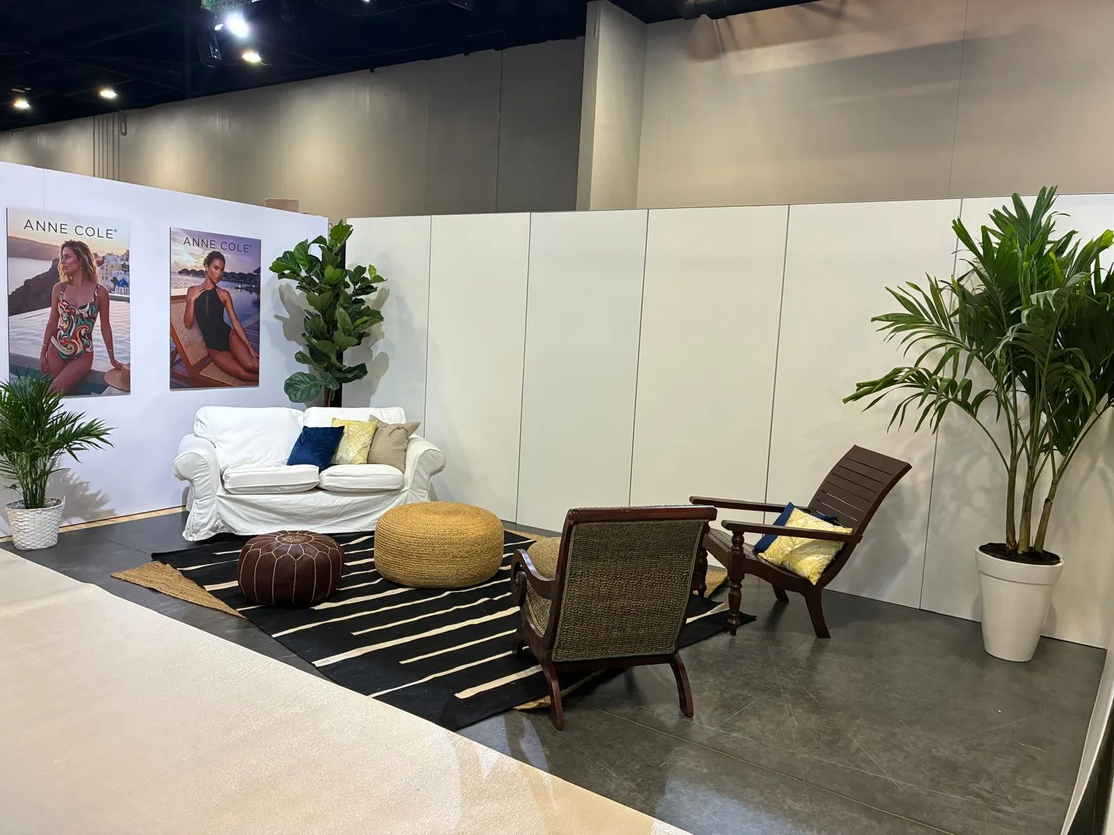 Palms and ferns framing a designer lounge vignette at an event