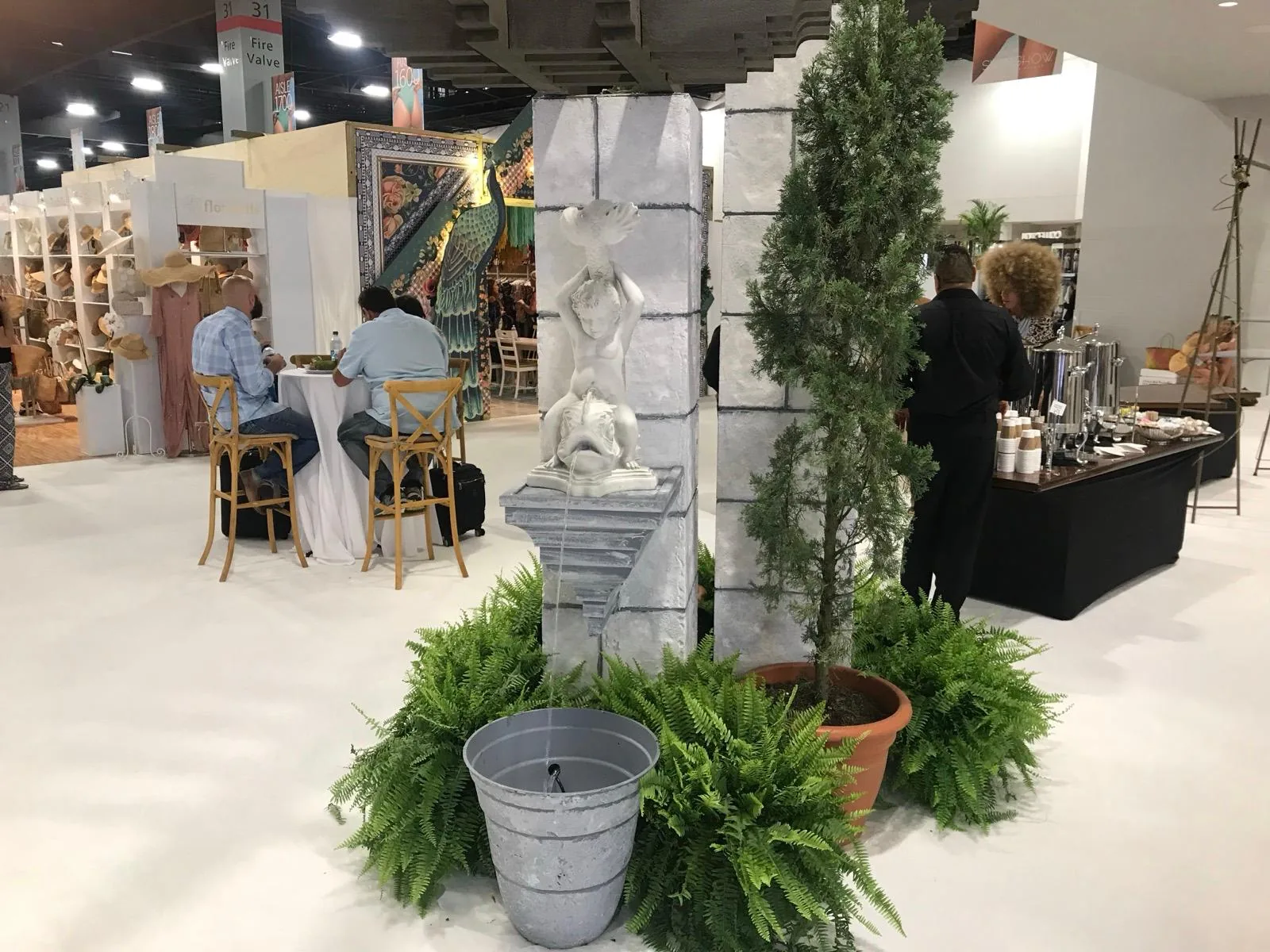 Cypress, ferns and statuary styling a themed trade show booth